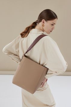 The Allured Medium Tote Bag is a smaller version of our beloved Allured Tote Bag. Its rectangular silhouette sits perfectly on the shoulder, with a wide leather strap that is adjustable with the belt loop detail. Lined with smooth leather, the bag can fit an 11" laptop, making it an ideal everyday tote. Optional Add-ons: Webbing Shoulder Strap; AirPods Pro Case. Medium Tote Bag, Airpods Pro Case, Work Tote, Lightweight Bag, Everyday Tote, Medium Tote, How To Make Shorts, Work Bag, Add Ons