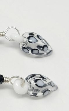 pair of earrings with black and white beads on silver plated earwires or hooks