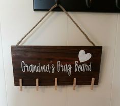 a sign hanging on the wall that says grandma's drag board with hearts attached to it