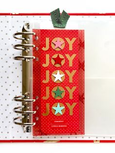 an open notebook with christmas decorations on it