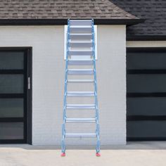 a ladder leaning against the side of a white brick building next to a black garage door