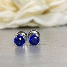 "The earrings pictured are lab created blue sapphire #5791 We feature the finest quality lab grown sapphires in the world. The properties of lab-grown are physically, chemically and visually identical to natural, just grown in a lab setting. -Approximate total carat weight: 1.00ctw diamond equivalent -Stone Size: approx. 0.50ct each diamond equivalent -Stone Shape: round 5mm each -Gem Type: lab created blue sapphire -Stone Clarity: VS2 -Stone Color: Blue -Moh's Scale: 9 hardness -Metal Type and Classic Sapphire Birthstone Earrings, Sapphire Birthstone Earrings For Formal Occasions, Classic Round Tanzanite Earrings, Fine Jewelry Sapphire Round Cut Earrings, Blue Tanzanite Brilliant Cut Earrings, Brilliant Cut Tanzanite Blue Earrings, Ethical Sapphire White Gold Earrings, Formal Sapphire Earrings With Birthstone, Round Tanzanite Earrings For Gifts