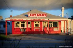 a red and white diner sitting on the side of a road