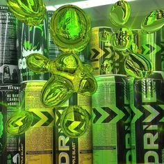 many cans of energy drink are stacked on top of each other in this artistic photo