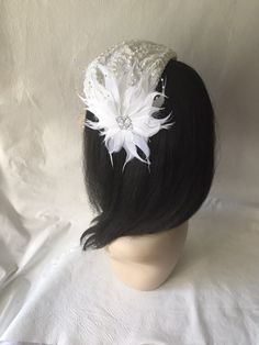 This is a vintage inspired half hat feather flower fascinator ideal for wedding, bridal tea party, mother of the bride, COGIC church hat or any other formal special occasion. Lightweight Can be worn either side Alligator clips underneath or elastic band White Costume Hat With Round Crown For Parties, Handmade White Wedding Hat, Elegant Handmade White Headband, White Gatsby Style Fascinator For Party, Handmade White Wedding Fascinator, Vintage White Headpieces For Evening, Fitted White Headpiece With Pinched Crown, White Fitted Headpiece With Pinched Crown, Handmade White Mini Hats For Wedding