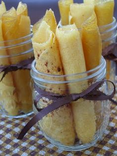 small glass jars filled with food on top of a table