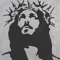 a black and white drawing of jesus on the side of a building