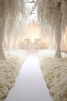 an aisle with white flowers and drapes