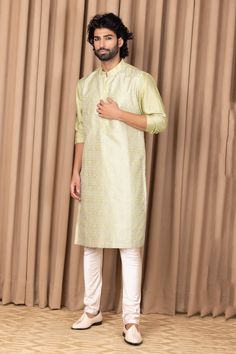 Mint green straight kurta with embroidery on the front. Comes with an ivory churidar.
Component: 2
Pattern: Embroidered
Neckline: Mandarin Collar
Sleeve Type: Straight Long
Fabric: Cotton and Silk
Color: Green
Other Details: 
Front button placket
Note: Pant worn by the model is not for sale
Occasion: Mehendi and Puja - Aza Fashions Modern Groom, Kurta Set For Men, Silk Kurta, Embroidered Neckline, Churidar, Kurta Set, Embroidered Silk, Men's Grooming, Green Cotton