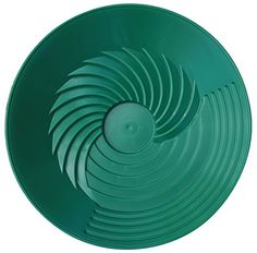 an image of a green plate that is on the table with it's spiral design