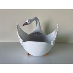 a white and grey swan shaped bowl on a table