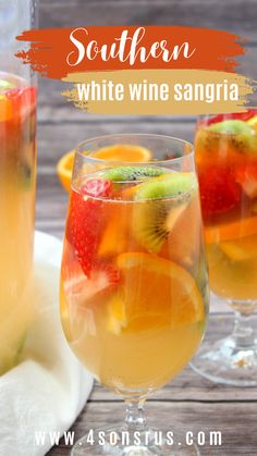 two glasses filled with white wine sangria on top of a wooden table