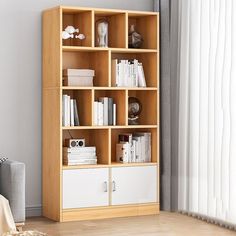 a living room with a book shelf and a chair next to the window in front of it