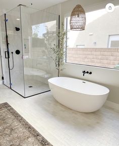 a white bath tub sitting next to a walk in shower