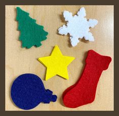 felt christmas ornaments on a wooden surface