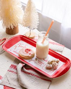 a tray with cookies and milk on it