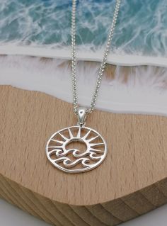 "Beautiful Shining Sterling Silver Open Sun and Wave Pendant with 16\"-18\" adjustable belcher chain.  Other chain lengths are available. This is a beautiful feel good pendant that will bring you back to those sunny days spent on the beach.   An ideal gift for all those sun lovers we know! Dimensions Width 19mm's, Height 19mm's If you are buying this as a gift for someone and want to make it extra special, how about adding one of our Messages in a Bottle...  We have 6 bottle designs to choose from and a  number of different messages and quotes that can be included on your scroll. Please follow the following link for our Messages in a bottle. https://oceansofsilvershop.etsy.com/uk/listing/1168876950/message-in-a-bottle-keepsake Your Message in a bottle will be delivered with your Jewellery. Messages In A Bottle, Green Onyx Necklace, Dragon Hand, Wave Pendant, Bottle Designs, Wave Necklace, Onyx Necklace, Star Earrings Stud, Star Studs