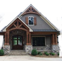 a house with stone and wood trim around the front door