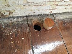 two wooden cups sitting on the floor next to each other