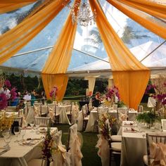 the inside of a tent with tables and chairs