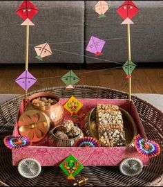 a tray filled with lots of food on top of a wicker table next to a couch