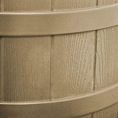 a close up view of the side of a plastic barrel with woodgrain on it