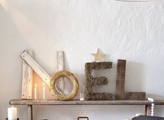 a shelf that has some candles on it and other items sitting on top of it