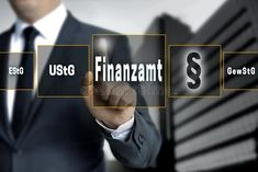 a man in a suit pointing to the word finance