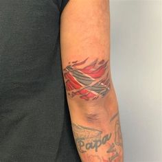 a man's arm with tattoos on it and the word papa written in red ink