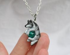 "A perfect gift for yourself or the wolf lover in your life! This dashing double sided wolf was hand sculpted from polymer clay and painted with acrylic paints and metallic rub, then finished with a durable sealant. From ear to tail the wolf measures approximately 1 inch Included is a crackled bead of your color choice, gem \"P\" is the color shown with the wolf in the example photos. **NOTE** Your order is made to order and is unique, I will usually have your item made and in the mail within 2- Themed Polymer Clay Jewelry For Gifts, Themed Hand Painted Jewelry For Gifts, Hand Painted Silver Polymer Clay Necklace, Silver Hand-painted Resin Necklace, Hand Painted Silver Resin Necklace, Silver Hand Painted Resin Necklace, Wolf Jewelry Necklaces, Wolf Stuff, Wolf Necklace