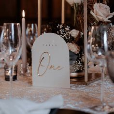 a close up of a table with wine glasses and place cards on top of it