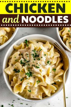 two bowls filled with chicken and noodles on top of a white table next to silverware