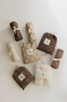 several small bags with brown and white designs on them