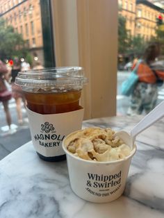 two cups of food sitting on top of a table