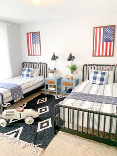 a bedroom with two twin beds and an american flag on the wall