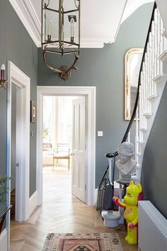 an image of a hallway with blue walls and white trim on the door way, and a yellow fire hydrant next to it