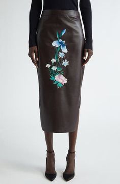 The season's blooming iris centers the front of this lambskin-leather skirt cut in a low-high silhouette, making it a midi in front and knee length in back. Hidden side-zip closure Low-high hem Leather Professional leather clean Made in Italy Designer Clothing Luxury Spring Skirt, Spring Brown Leather Skirt, Brown Leather Skirt For Spring, Jacquard Skirt, Pencil Skirt Black, Black Midi Skirt, Denim Midi Skirt, Asymmetrical Skirt, Lambskin Leather