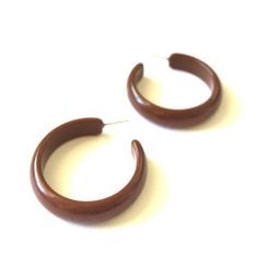 "Dark chocolate brown hoop earrings in a great shiny finish in a marblized lucite. I love this size hoop! 1.25\" in diameter & about 10mm in width. Big enough to make a statement, but the right sized statement. This style hoop is known as the \"Midi\" hoop & is available in loads of other colors. You can put the word \"Midi\" into the Shop Search & see all the options. The model is wearing it in the Ice Blue so you can get an idea of size & scale. All earrings are made with vinta Trendy Brown Hoop Earrings For Everyday, Brown Small Hoop Earrings As Gift, Hypoallergenic Brown Hoop Earrings As Gift, Brown Small Hoop Earrings For Everyday, Brown Hoop Earrings For Gift, Brown Round Hoop Earrings For Gift, Black Hoops Earrings, Cobalt Blue Earrings, Surgical Steel Earrings