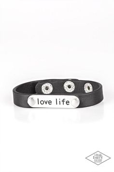 A silver plate engraved with the inspirational phrase “love life” is studded in place along a skinny strip of black, white, or pink leather. Brushed in a shiny finish, the dainty band wraps around the wrist in a colorfully seasonal style. Features an adjustable snap closure. Available colors are: Black, White, and Pink Silver Earrings Outfit, Snap Words, Dainty Band, Diamond Life, Word Bracelet, Snap Bracelets, Black Bracelets, Paparazzi Accessories, Urban Wear