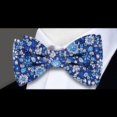 Blooms of Elegance: The Shades of Blue and White Floral Silk Bow Tie A Garden of Style Blooms in Every Knot In the world of men's fashion, a bow tie is not just an accessory; it's an emblem of style and individuality. Our Shades of Blue and White Floral Silk Bow Tie transcends traditional boundaries, offering a garden of intricate flowers that tell a story of elegance and sophistication. In this blog post, we immerse ourselves in the details of this silk masterpiece, exploring styling options, p Blue Bow Tie With Butterfly Knot For Formal Events, Classic Blue Bow With Butterfly Knot, Classic Blue Bow Tie With Butterfly Knot, Summer Blue Bow Tie And Accessories, Summer Blue Bow Tie And Suit Accessories, Summer Blue Bow Tie Suit Accessories, Elegant Blue Bow Tie For Spring, Blue Bow Tie With Bow Tie Back For Summer, Blue Bow Ties For Black Tie Occasions