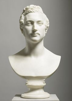 a white bust of a woman on a pedestal