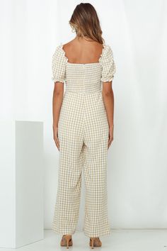 Length: Inside Leg: 71cm; Front Rise: 36cm; Leg Cuff: 64cm (of size S). Beige gingham print jumpsuit. Partially lined. Cold hand wash only. Model is a standard XS and is wearing size XS. True to size. Lightweight, non-stretchy woven cotton fabric. Ruched drawstring to bust. Shirred, stretchy back panel. Invisible back zipper. Print placement may vary. 100% Cotton. Combine your fave cottage core aesthetic you've been loving on Pinterest with the hottest of styles this weekend wearing our Your Love Is Mine Jumpsuit. It features a vintage gingham check print throughout, features a Queen Anne neckline with an adjustable ruched drawstring detail, and matching puff sleeves. This jumpsuit comes with straight-leg pants and a stretchy shirred back panel for all-day comfort. Beige Gingham, Queen Anne Neckline, Cottage Core Aesthetic, Print Jumpsuit, Leg Cuffs, Love Is, + Core + Aesthetic, Printed Jumpsuit, Gingham Print