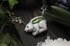 This beautiful spring rabbit necklace with painted snowdrops is a great gift for fantasy lovers, for those who look for deep forest atmosphere, for forest jewelry fans, it's a great charm for the forest witch. This spring hare charm is a great gift for those who look for a totem hare necklace and for a druid fantasy atmosphere. Pendant is made of polymer clay, hand-painted with acrylic for miniatures and pastel, and covered with glaze. The ears of the hare are decorated with painted snowdrops. S White Fantasy Necklace As Gift, White Handmade Fantasy Necklace, Handmade Fantasy White Necklace, Jackrabbits Necklace, Silver Bunny Design Jewelry Gift, Hare Necklace, Bunny Necklace Jewelry, Rabbit Necklace Pendants, Rabbit Necklaces