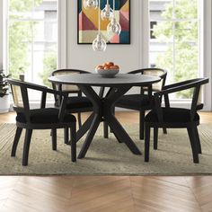 Dine, converse, and spend quality time with your favorite people and this gorgeous 5-piece dining set. It includes a round table and four armchairs, each piece crafted from solid acacia wood with a bold black finish. The table's slatted top and sculptural pedestal base bring a hint of modern style to your space, while the chairs' cane web backrests add lots of breezy coastal charm. The seats are upholstered and generously padded to provide just the right amount of support as you enjoy dinner and Black Round Dining Table, Rattan Dining Table, Acacia Wood Table, Round Dining Table Sets, Round Dining Set, Solid Wood Dining Set, Black Dining Room, 5 Piece Dining Set, Dining Table Black