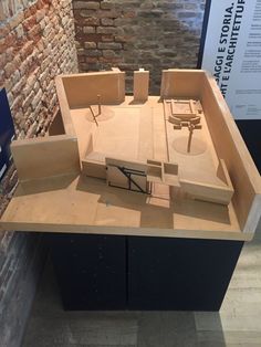 a model of a building made out of plywood and wood on display in a museum