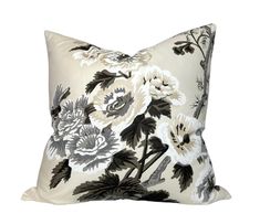 a black and white pillow with flowers on it