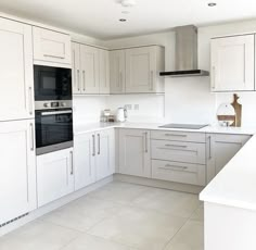 a kitchen with white cabinets and an oven