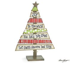 a wooden christmas tree with the words joy to the world and let each receive their king