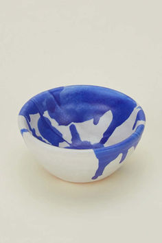 a blue and white bowl sitting on top of a table