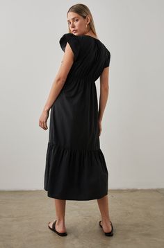 The Tina Dress expertly combines comfort and style for a no-fuss, effortless look you'll reach for over and over. It has a v-neckline with a delicate cutout, flutter sleeves, and an empire waist. Rendered in a crisp cotton poplin, the tiered, midi dress in black is ready for exploring, brunch, even the office.55% Cotton | 45% Tencel.Imported. Recommend ordering true to size.Front Body Length: 48 1/8” (Measured from Small)Model is wearing size S. First model is wearing size S. Second model is wea Empire Waistline, Frill Sleeves, Tiered Midi Dress, Midi Length Skirts, Midi Length Dress, Flutter Sleeves, Over It, Model Dress, Cotton Poplin